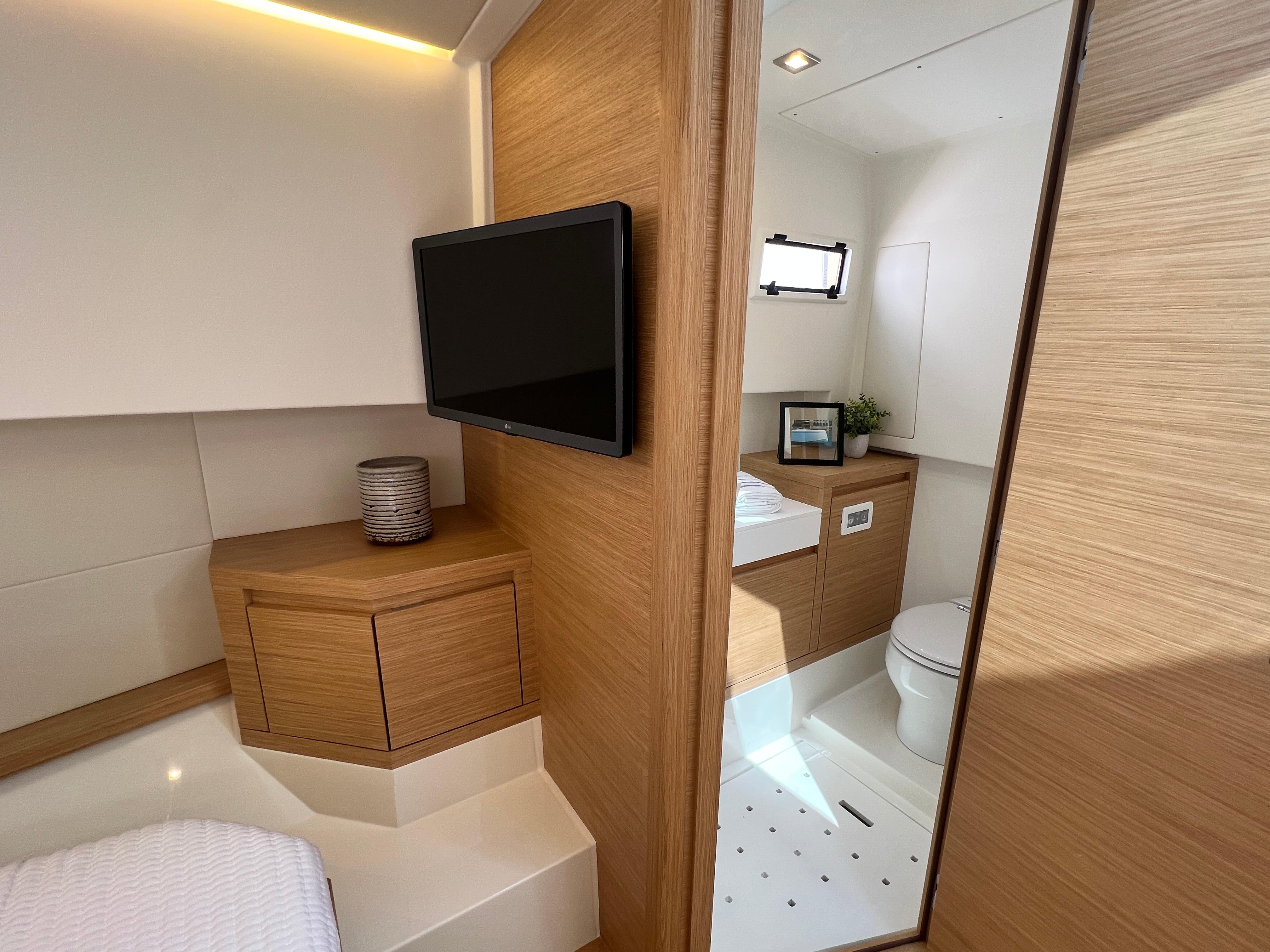Slide: The Image of Interior of 2025 Pardo Yachts 38 Outboard, featuring modern bathroom and wooden cabinetry. - 23