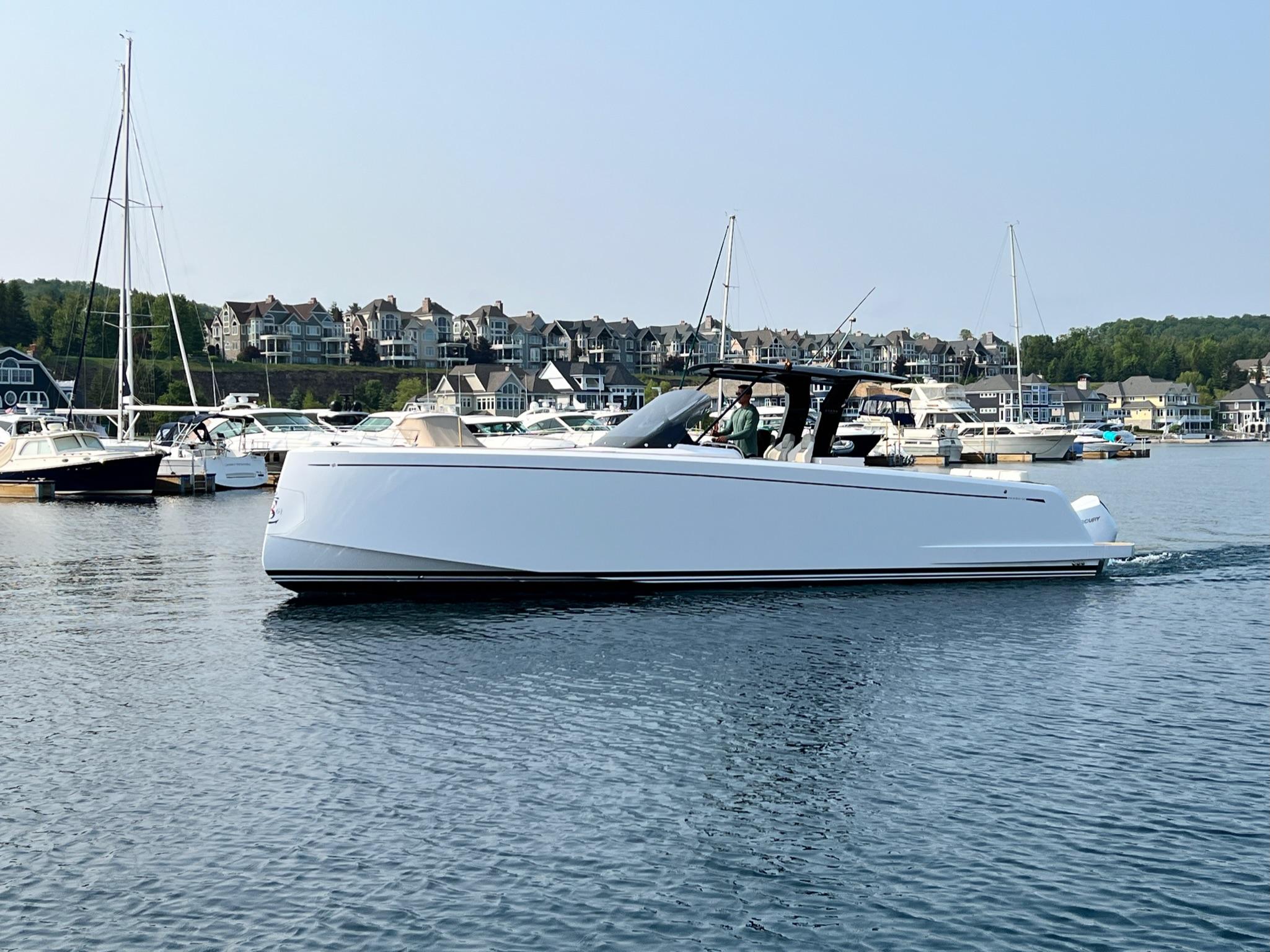 Slide: The Image of 2025 Pardo Yachts 38 Outboard cruising in a marina with waterfront homes. - 4