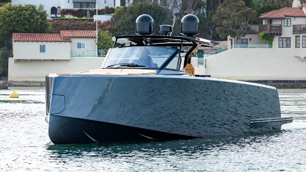 Slide: The Image of 2022 Pardo Yachts 50 cruising on water near coastal homes. - 13