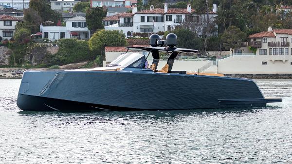 Slide: The Image of 2022 Pardo Yachts 50 luxury yacht on calm water near coastal homes. - 8