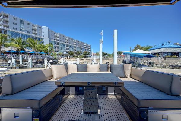 Slide: The Image of Luxury seating area on the 2025 Pardo Yachts 50, docked at a marina. - 19