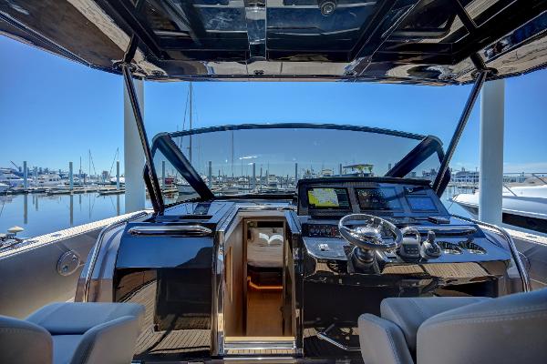 Slide: The Image of Cockpit view of 2025 Pardo Yachts 50 at marina, featuring modern navigation equipment. - 28