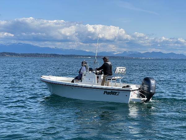Slide: The Image of 2023 Parker 1801 Center Console boat on open water with two people onboard. - 3