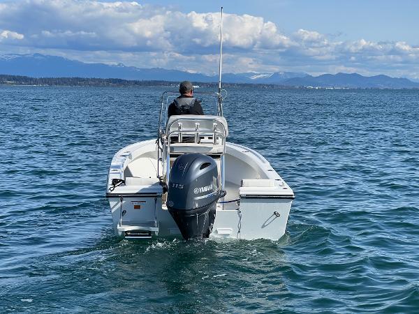 Slide: The Image of 2023 Parker 1801 Center Console boat on open water with Yamaha outboard motor. - 4