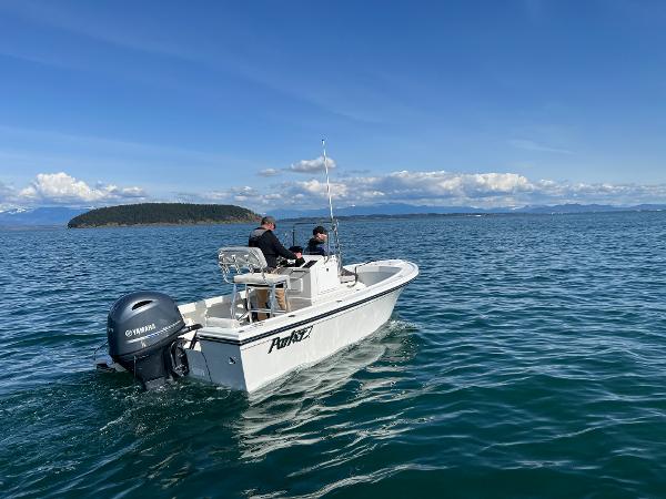 Slide: The Image of 2023 Parker 1801 Center Console boat cruising on a clear blue sea. - 5