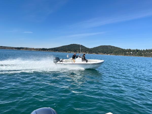 Slide: The Image of 2023 Parker 1801 Center Console boat cruising on a lake with hills in the background. - 7