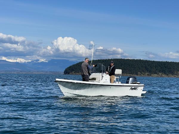 Slide: The Image of 2023 Parker 1801 Center Console boat on a scenic lake with two people onboard. - 8