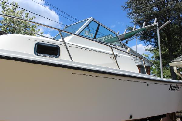 Slide: The Image of 1996 Parker 2110 Walkaround boat with white hull and cabin. - 11