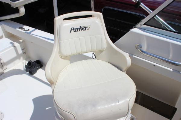 Slide: The Image of Parker 2110 Walkaround 1996 boat seat with white upholstery and Parker logo. - 19