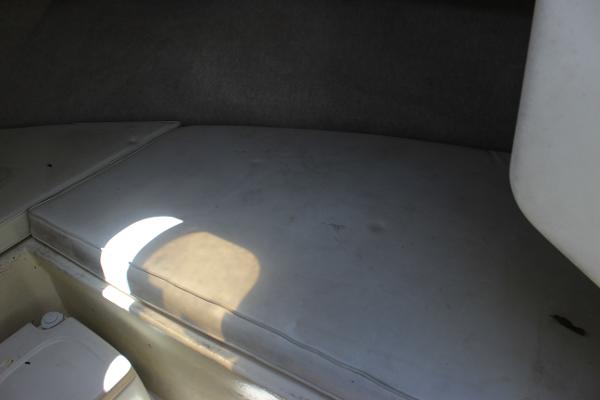 Slide: The Image of Interior cabin of a 1996 Parker 2110 Walkaround boat with cushioned seating. - 24