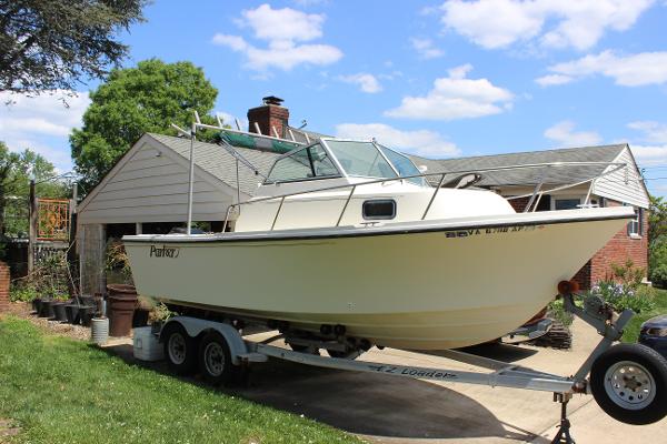 Slide: The Image of 1996 Parker 2110 Walkaround boat on a trailer in a residential driveway. - 3