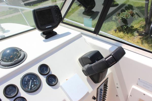 Slide: The Image of 1996 Parker 2110 Walkaround boat dashboard with steering wheel and gauges. - 31