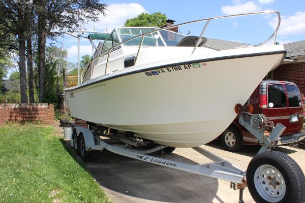Slide: The Image of 1996 Parker 2110 Walkaround boat on trailer in driveway. - 35