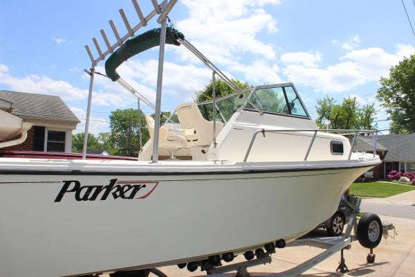 Slide: The Image of 1996 Parker 2110 Walkaround boat on a trailer in a residential driveway. - 5