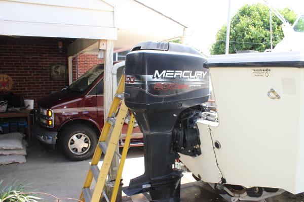 Slide: The Image of 1996 Parker 2110 Walkaround with Mercury 200 outboard motor in a driveway. - 6