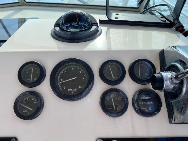 Slide: The Image of Dashboard of a 2002 Parker 2510 Walkaround boat with gauges and compass. - 11