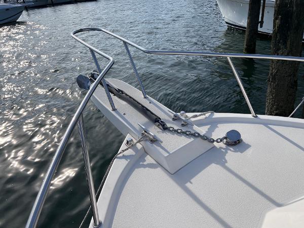 Slide: The Image of Bow of 2002 Parker 2510 Walkaround boat with anchor chain in marina. - 15