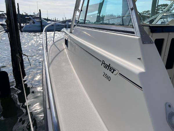 Slide: The Image of 2002 Parker 2510 Walkaround boat docked at a marina. - 16