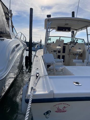 Slide: The Image of 2002 Parker 2510 Walkaround boat docked at marina. - 17