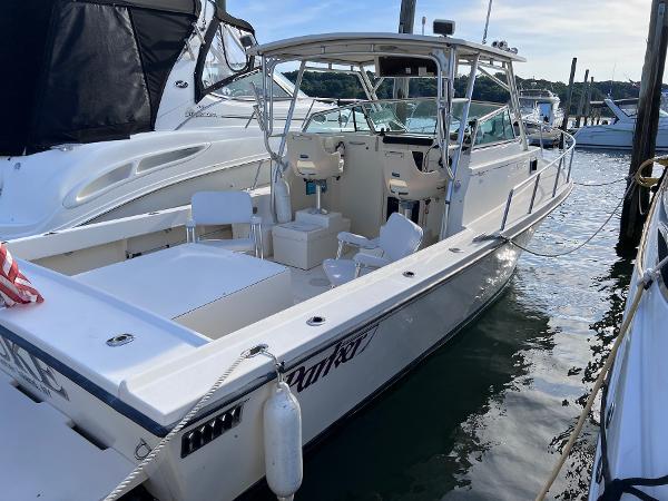 Slide: The Image of 2002 Parker 2510 Walkaround boat docked in a marina. - 2
