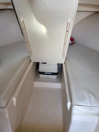 Slide: The Image of 2002 Parker 2510 Walkaround boat cabin interior with cushions and portable toilet. - 22