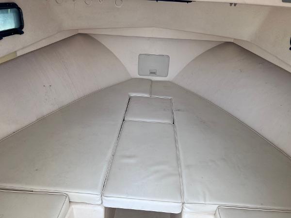 Slide: The Image of 2002 Parker 2510 Walkaround boat cabin with cushioned seating. - 23