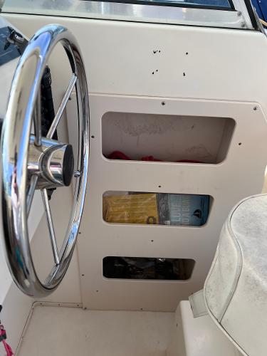 Slide: The Image of Steering console of a 2002 Parker 2510 Walkaround boat with storage compartments. - 5