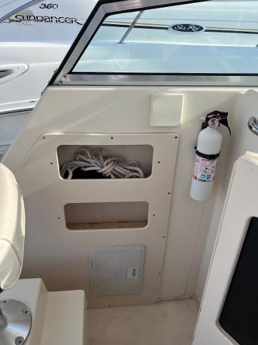 Slide: The Image of 2002 Parker 2510 Walkaround boat interior with storage compartments and fire extinguisher. - 7