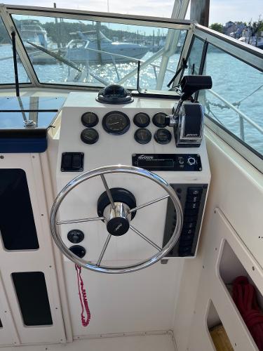 Slide: The Image of Steering console of a 2002 Parker 2510 Walkaround boat with gauges and controls. - 9