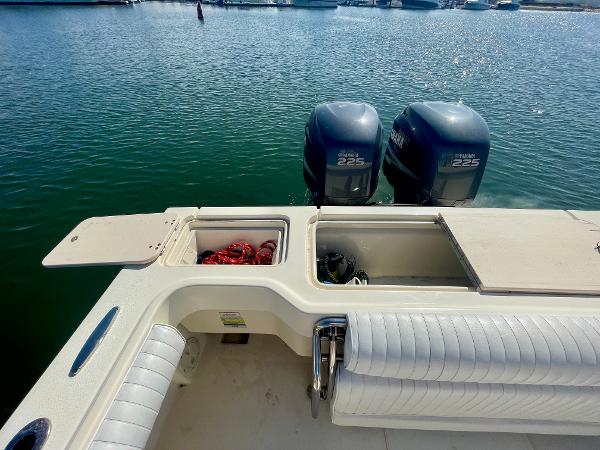 Slide: The Image of 2008 Parker 2520 DV boat with twin Yamaha 225 engines docked on calm water. - 22