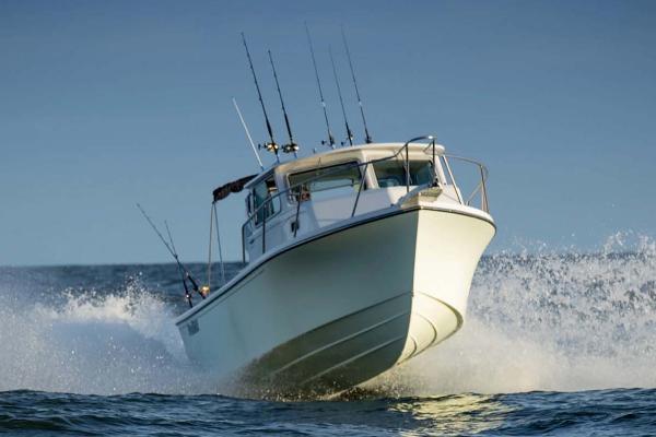 Slide: The Image of Manufacturer Provided Image: 2025 Parker 2820 XLD Sport Cabin boat cruising on the ocean. - 1