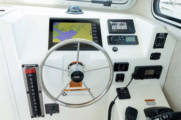 Slide: The Image of Manufacturer Provided Image: Parker 2820 XLD Sport Cabin 2025 boat dashboard with navigation and control systems. - 11