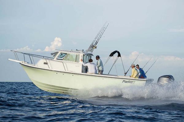 Slide: The Image of Manufacturer Provided Image: 2025 Parker 2820 XLD Sport Cabin boat cruising on the ocean with passengers. - 2