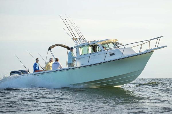 Slide: The Image of Manufacturer Provided Image: 2025 Parker 2820 XLD Sport Cabin boat cruising with passengers on open water. - 4