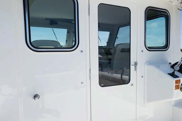 Slide: The Image of Manufacturer Provided Image: Parker 2820 XLD Sport Cabin 2025 model, exterior view of cabin door and windows. - 6