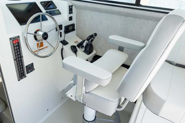 Slide: The Image of Manufacturer Provided Image: 2025 Parker 2820 XLD Sport Cabin helm with steering wheel, controls, and captain's chair. - 9