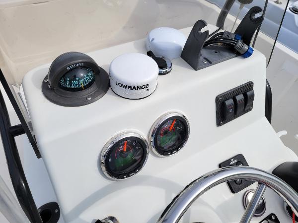 Slide: The Image of Pathfinder 1806V 2001 boat dashboard with compass, Lowrance device, and gauges. - 5