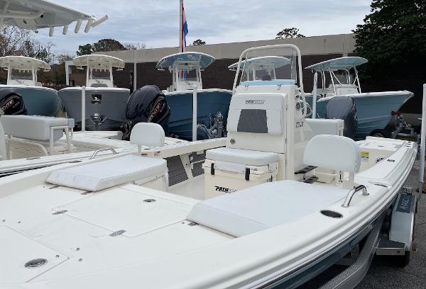 Slide: The Image of 2024 Pathfinder 2200 TRS boat displayed in a marina with other boats. - 11