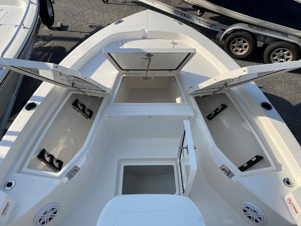 Slide: The Image of 2024 Pathfinder 2200 TRS boat with open storage compartments and clean white deck. - 14