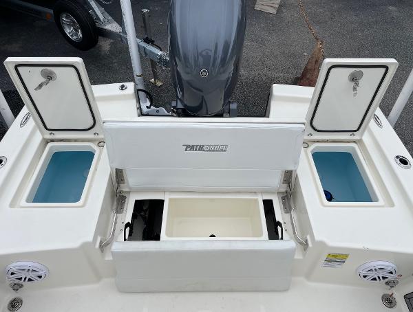 Slide: The Image of 2024 Pathfinder 2200 TRS boat with open storage compartments and Yamaha outboard motor. - 18