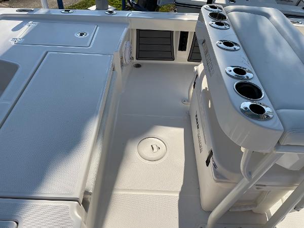 Slide: The Image of 2024 Pathfinder 2200 TRS boat deck with rod holders and storage compartments. - 20