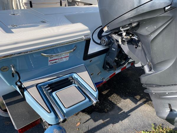 Slide: The Image of 2024 Pathfinder 2200 TRS boat with outboard motor and foldable swim ladder. - 25
