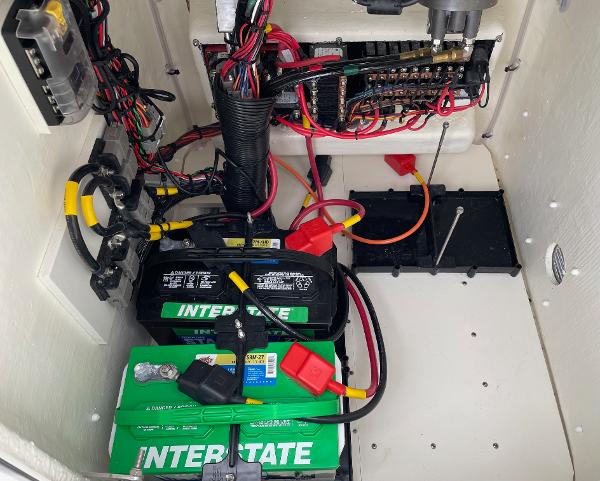 Slide: The Image of 2024 Pathfinder 2200 TRS boat battery compartment with Interstate batteries and wiring. - 27