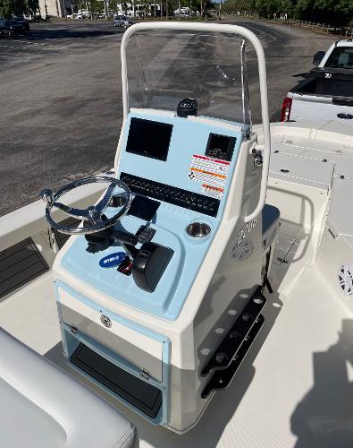 Slide: The Image of 2024 Pathfinder 2200 TRS boat console with steering wheel and navigation screens. - 6