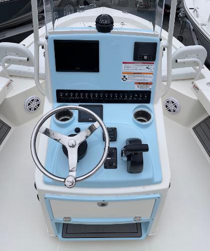 Slide: The Image of 2024 Pathfinder 2200 TRS boat console with steering wheel and control panel. - 7