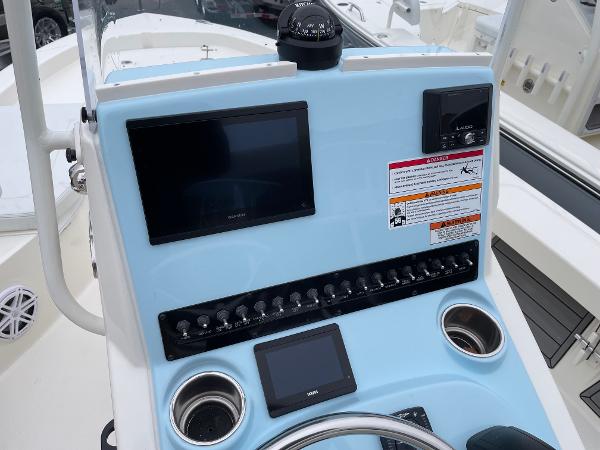 Slide: The Image of 2024 Pathfinder 2200 TRS boat console with navigation screens and controls. - 8