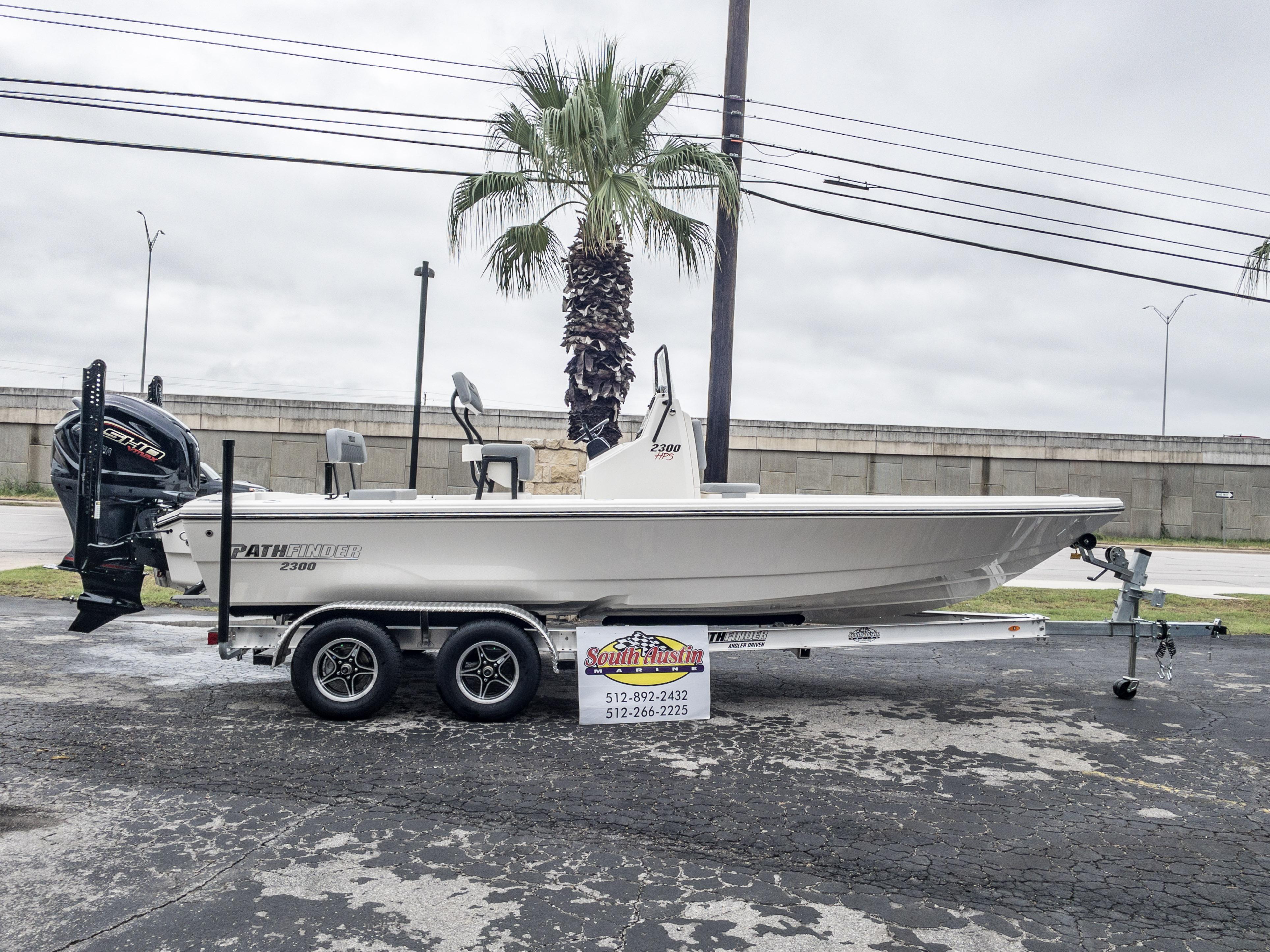 Slide: The Image of 2024 Pathfinder 2300 HPS boat on trailer, displayed outdoors. - 1
