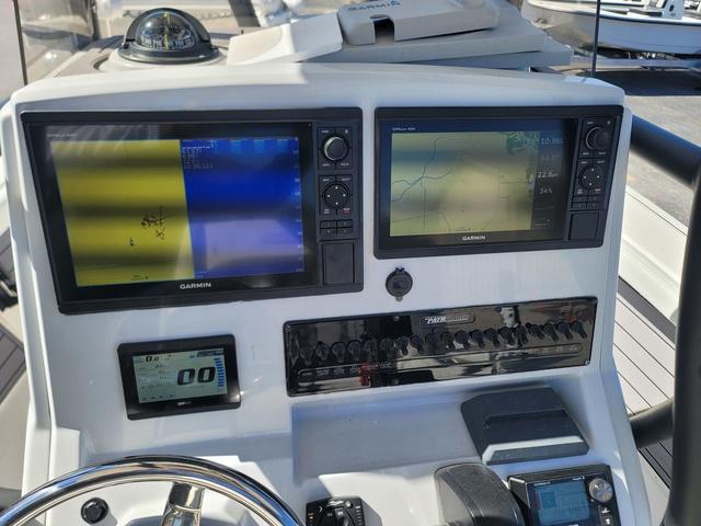Slide: The Image of 2023 Pathfinder 2400 Open boat dashboard with Garmin navigation displays. - 10