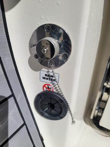 Slide: The Image of 2023 Pathfinder 2400 Open boat raw water intake with safety chain and warning label. - 15