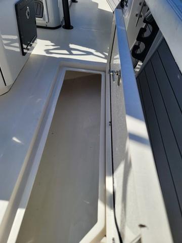 Slide: The Image of 2023 Pathfinder 2400 Open boat storage compartment, open and empty, with sleek interior design. - 18